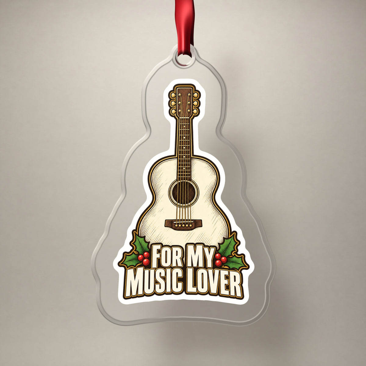 For My Music Lover Acoustic Guitar clear acrylic Christmas ornament on a plain studio backdrop with its red ribbon