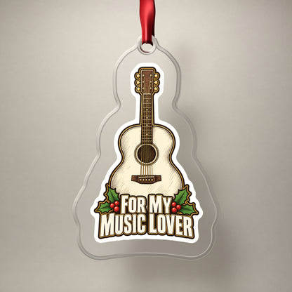 For My Music Lover Acoustic Guitar clear acrylic Christmas ornament on a plain studio backdrop with its red ribbon