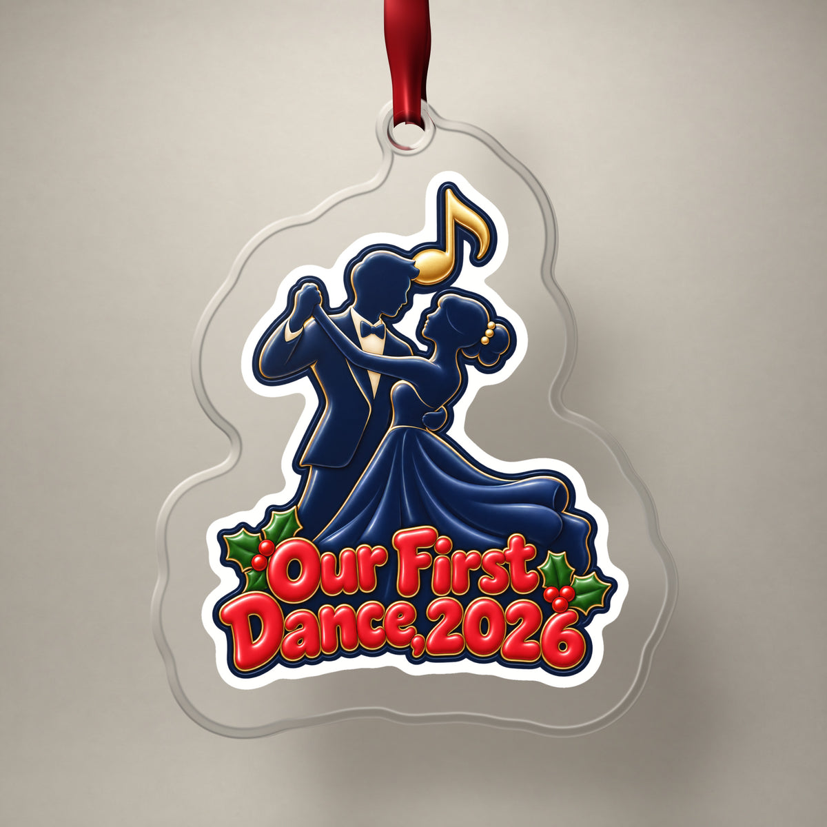 Our First Dance 2026 Couple clear acrylic Christmas ornament on a plain studio backdrop with its red ribbon