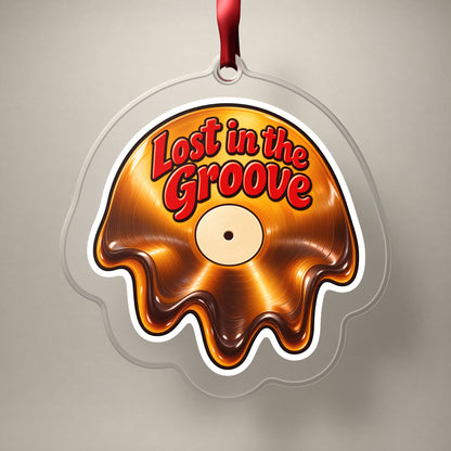 Lost in the Groove Melting Vinyl clear acrylic Christmas ornament on a plain studio backdrop with its red ribbon