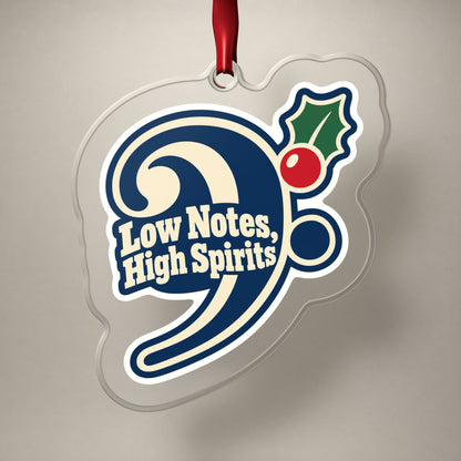 Low Notes, High Spirits Bass Clef clear acrylic Christmas ornament on a plain studio backdrop with its red ribbon