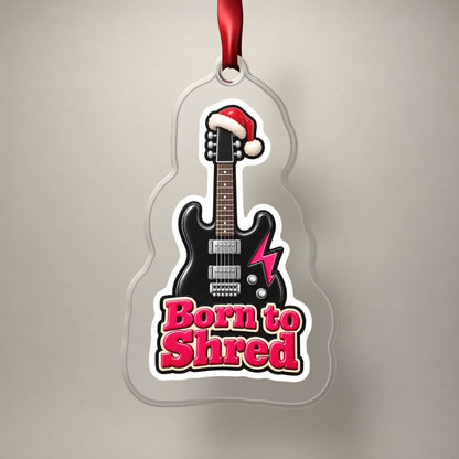 Born to Shred Electric Guitar clear acrylic Christmas ornament on a plain studio backdrop with its red ribbon