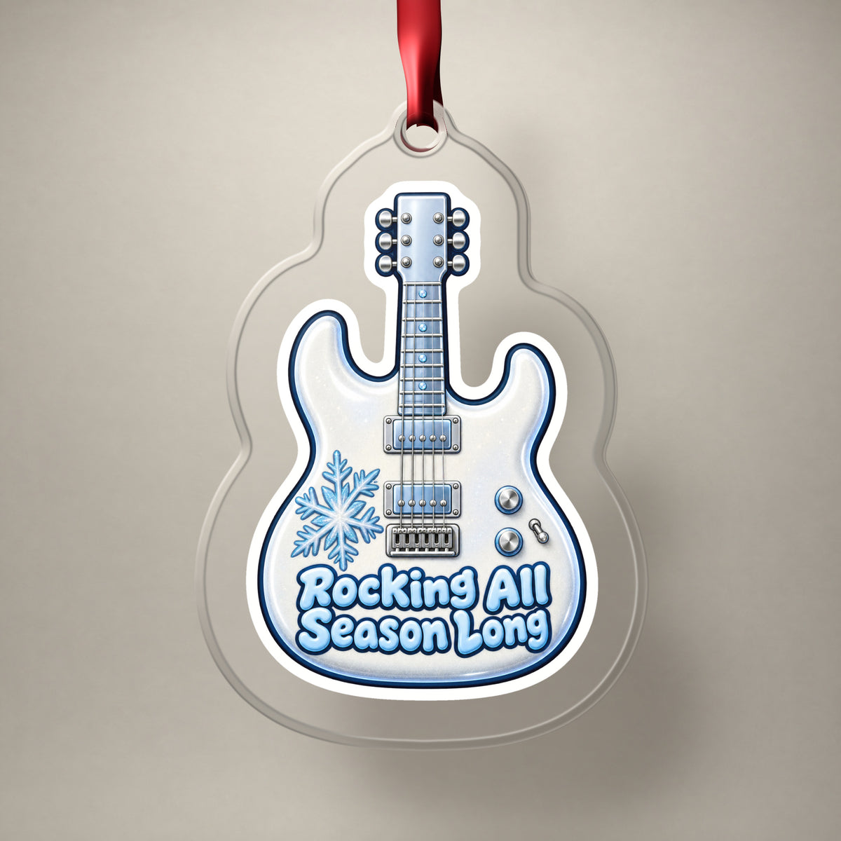 Rocking All Season Electric Guitar clear acrylic Christmas ornament on a plain studio backdrop with its red ribbon