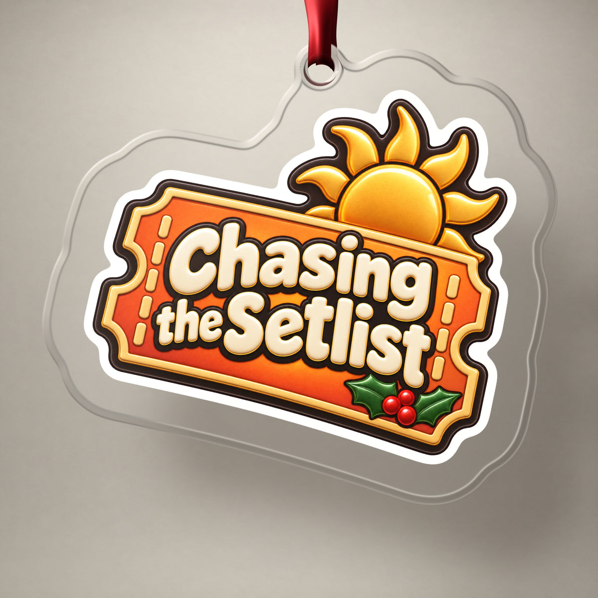 Chasing the Setlist Festival Ticket clear acrylic Christmas ornament on a plain studio backdrop with its red ribbon