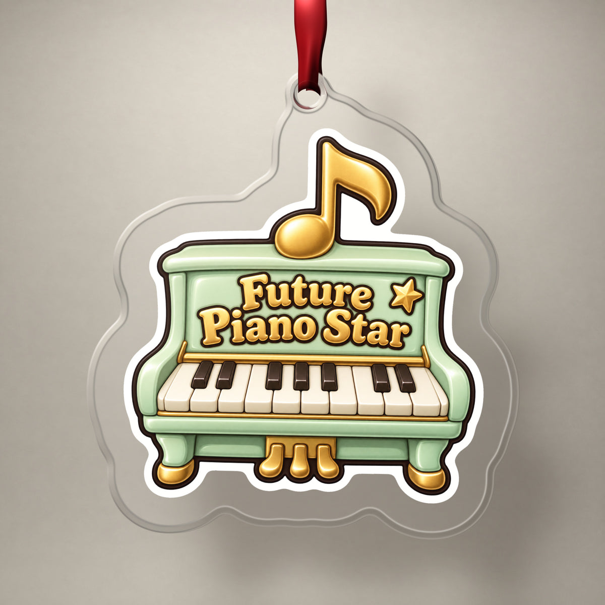 Future Piano Star clear acrylic Christmas ornament on a plain studio backdrop with its red ribbon