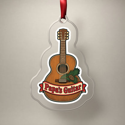 Papa's Guitar Christmas Ornament for Grandpa clear acrylic Christmas ornament on a plain studio backdrop with its red ribbon