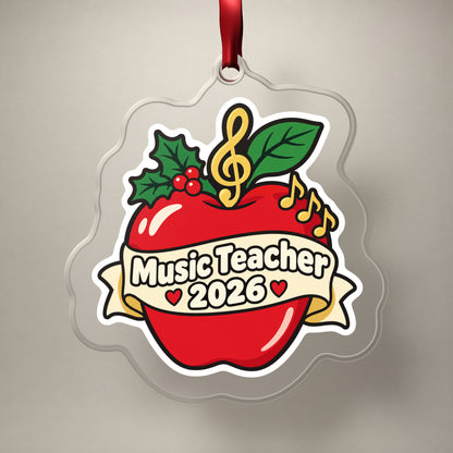 Music Teacher 2026 clear acrylic Christmas ornament on a plain studio backdrop with its red ribbon