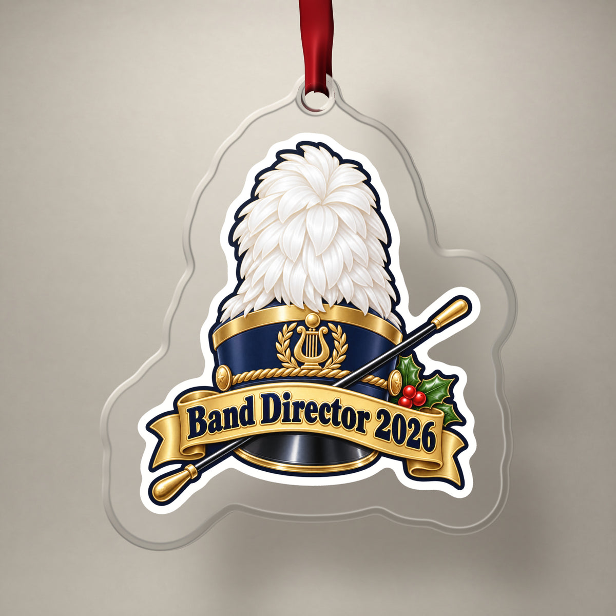 Band Director 2026 clear acrylic Christmas ornament on a plain studio backdrop with its red ribbon
