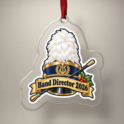Band Director 2026 clear acrylic Christmas ornament on a plain studio backdrop with its red ribbon
