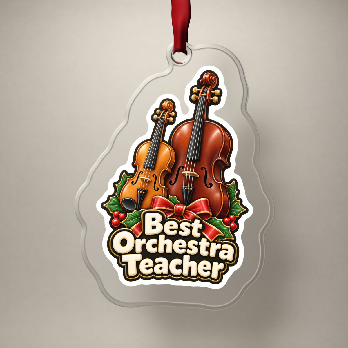 Best Orchestra Teacher clear acrylic Christmas ornament on a plain studio backdrop with its red ribbon