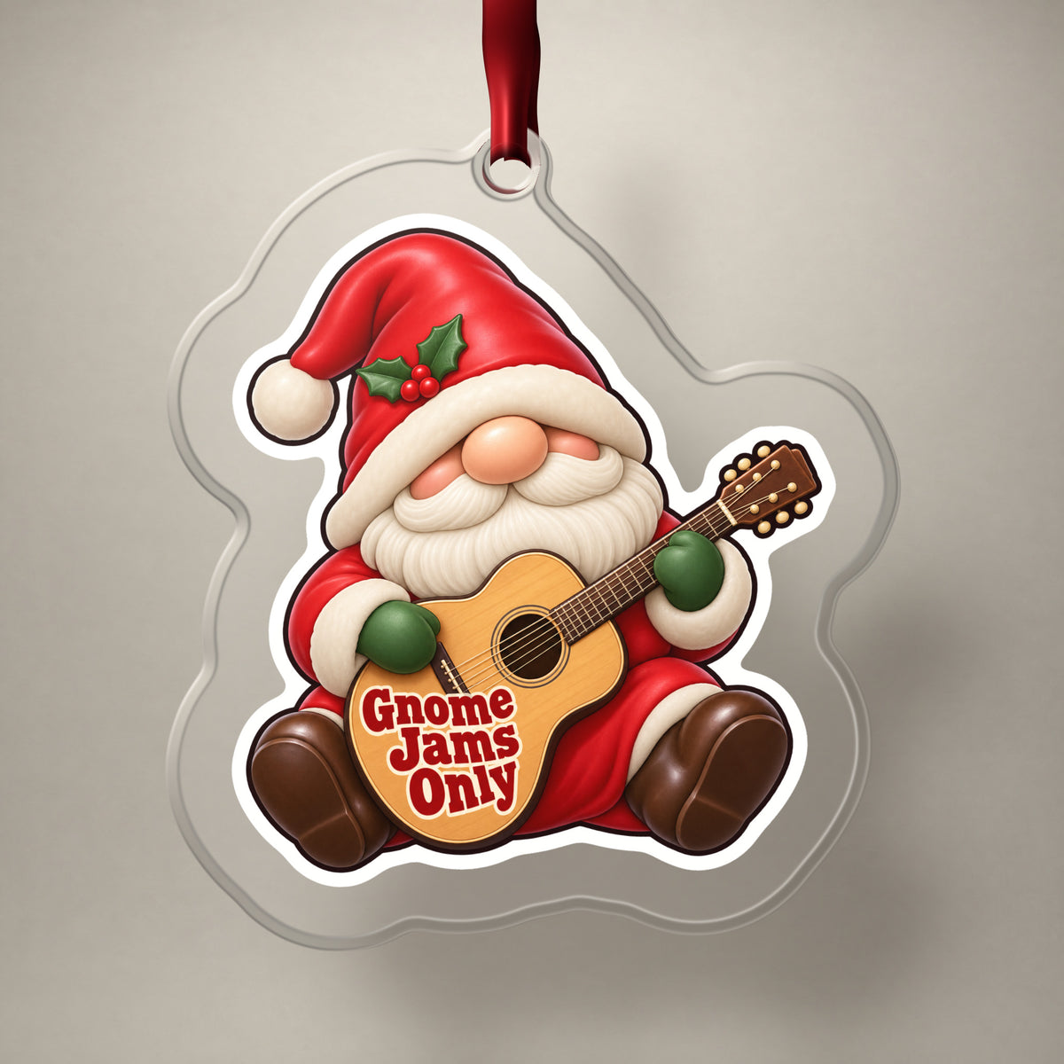 Gnome Jams Only Guitar Gnome clear acrylic Christmas ornament on a plain studio backdrop with its red ribbon