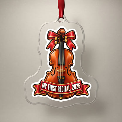 My First Violin Recital 2026 clear acrylic Christmas ornament on a plain studio backdrop with its red ribbon