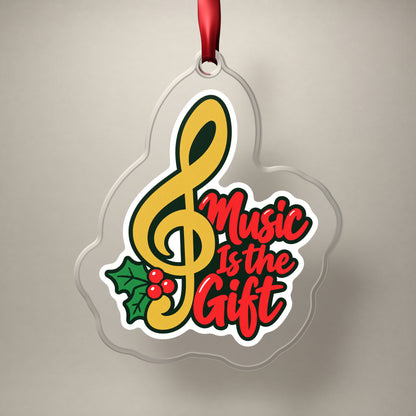 Music Is the Gift Treble Clef clear acrylic Christmas ornament on a plain studio backdrop with its red ribbon