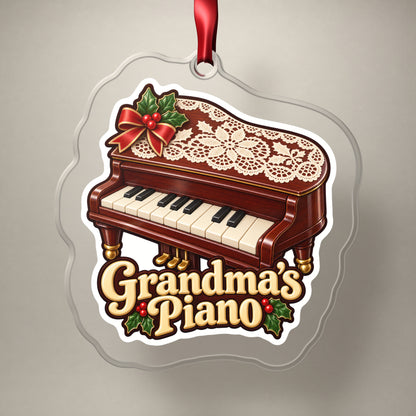 Grandma's Piano clear acrylic Christmas ornament on a plain studio backdrop with its red ribbon