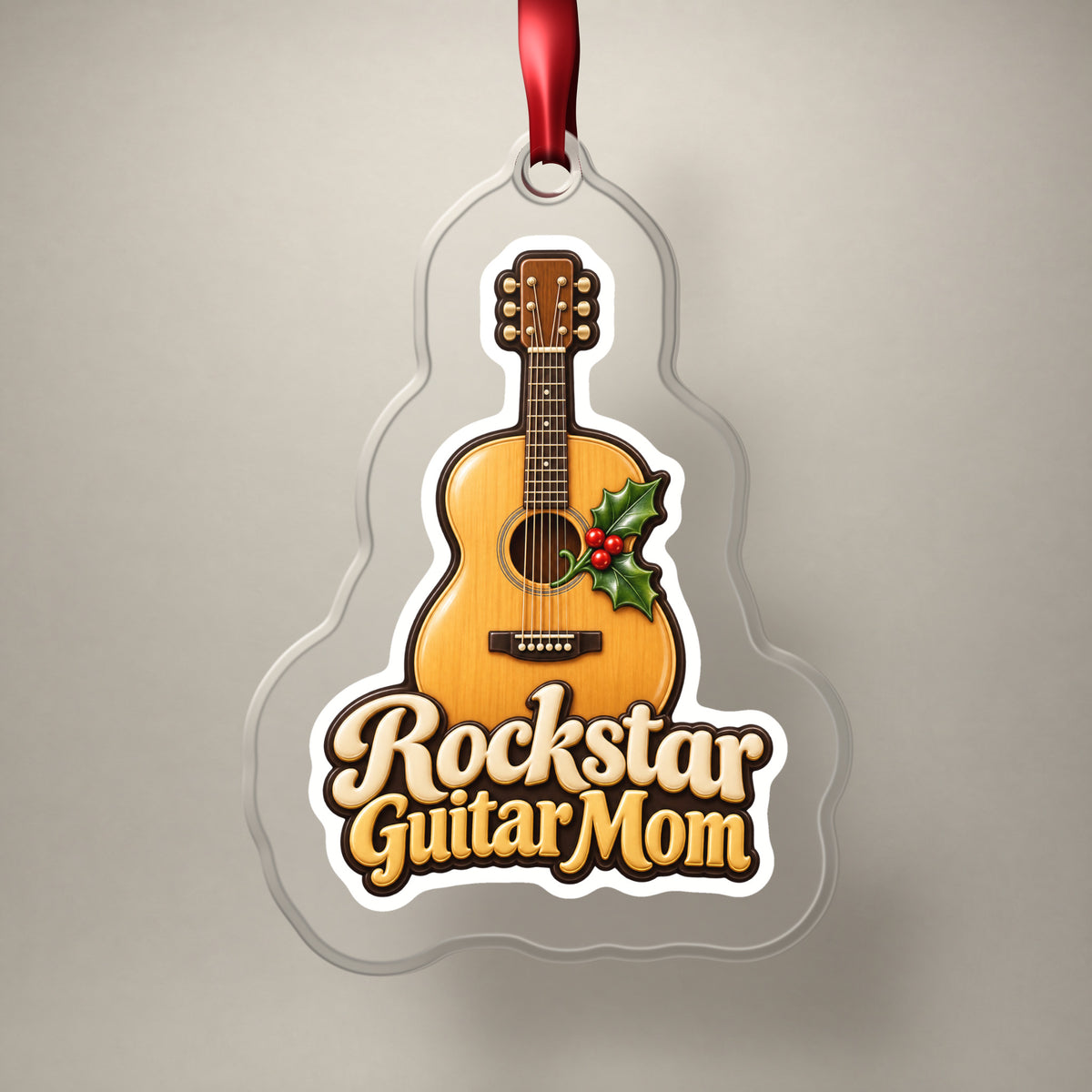 Rockstar Guitar Mom clear acrylic Christmas ornament on a plain studio backdrop with its red ribbon