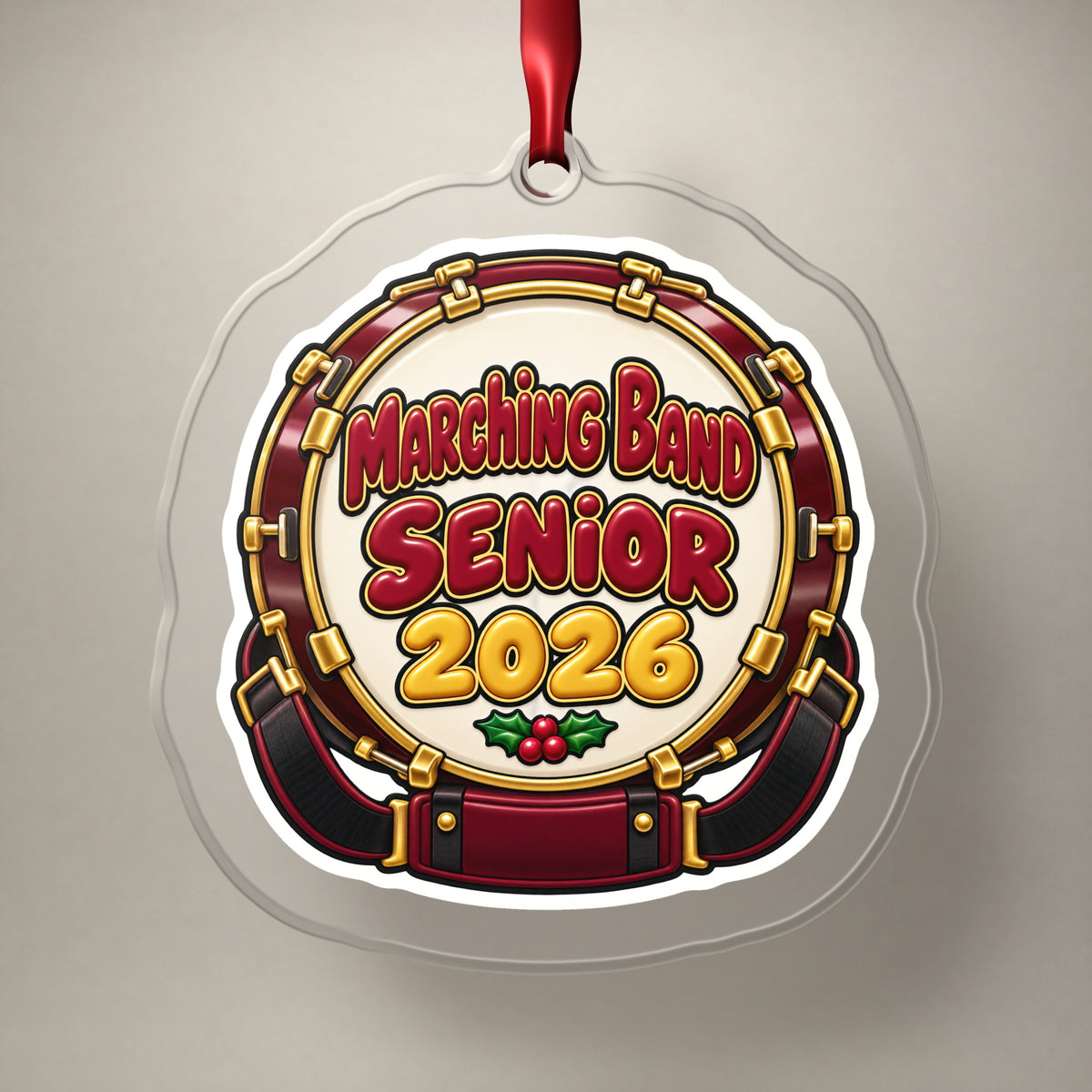 Marching Band Senior 2026 clear acrylic Christmas ornament on a plain studio backdrop with its red ribbon