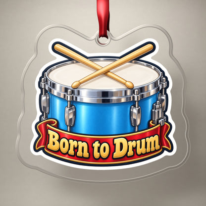 Born to Drum Snare Drum clear acrylic Christmas ornament on a plain studio backdrop with its red ribbon