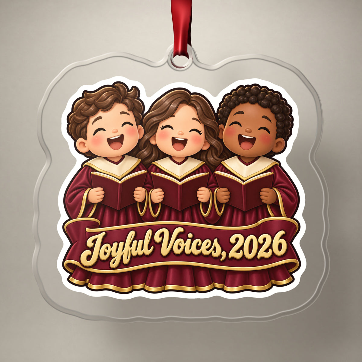 Joyful Voices 2026 Choir clear acrylic Christmas ornament on a plain studio backdrop with its red ribbon
