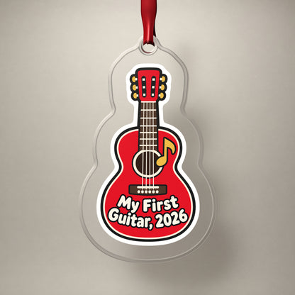 My First Guitar 2026 clear acrylic Christmas ornament on a plain studio backdrop with its red ribbon
