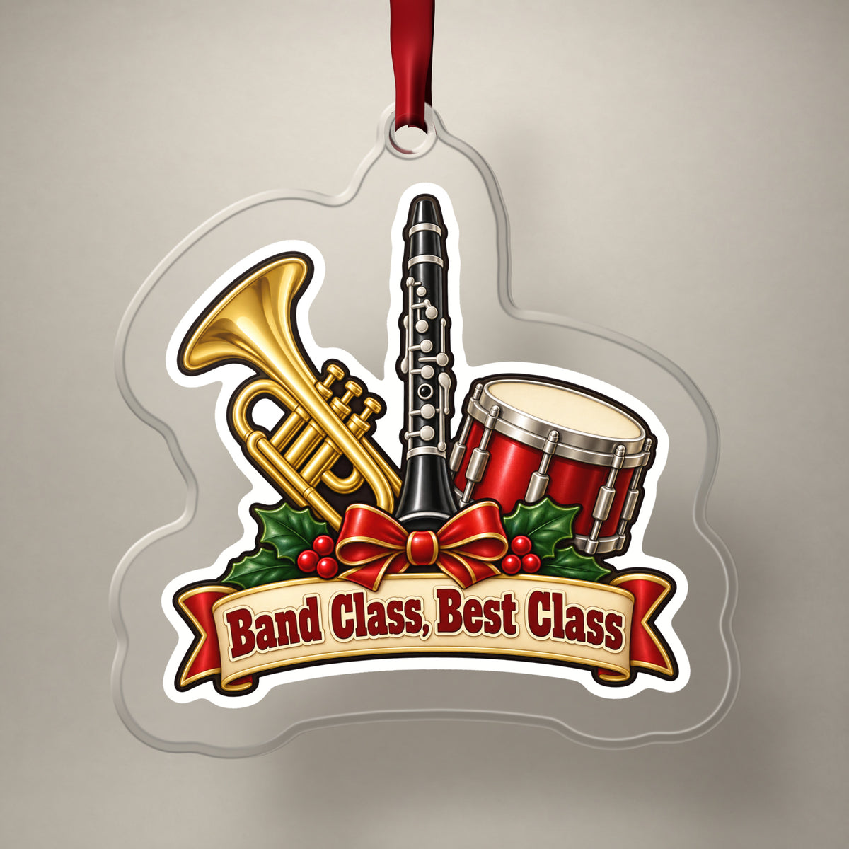 Band Class, Best Class School Band clear acrylic Christmas ornament on a plain studio backdrop with its red ribbon
