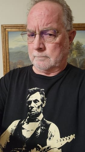 Randy P.'s photo: a close-up of a man in glasses wearing the black Lincoln Guitar tee.
