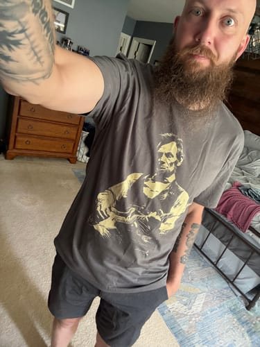 Andrew S. taking a selfie in the grey Lincoln Guitar tee