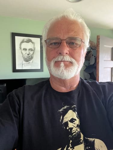John W. wearing the black Lincoln Guitar tee